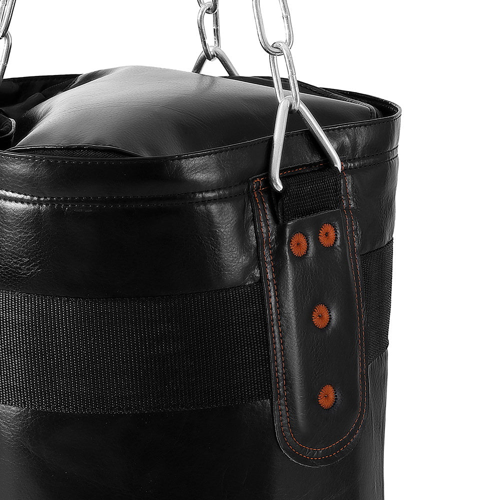 Black leather punching bag with chain and strap on a white background