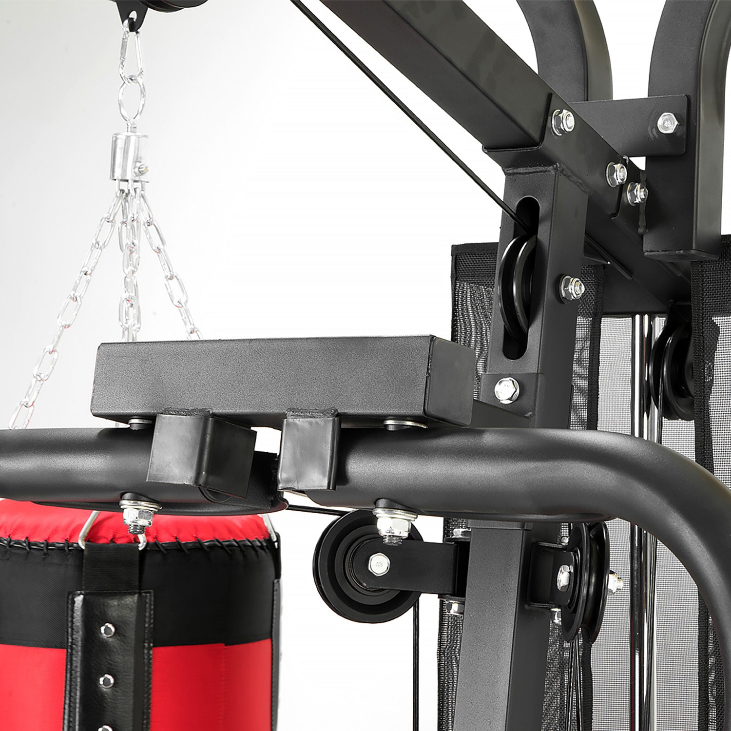 Close-up of a punching bag attachment on a fitness machine with a white background