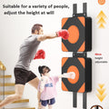 Two people using a adjustable boxing pad on a wall with text indicating adjustability.