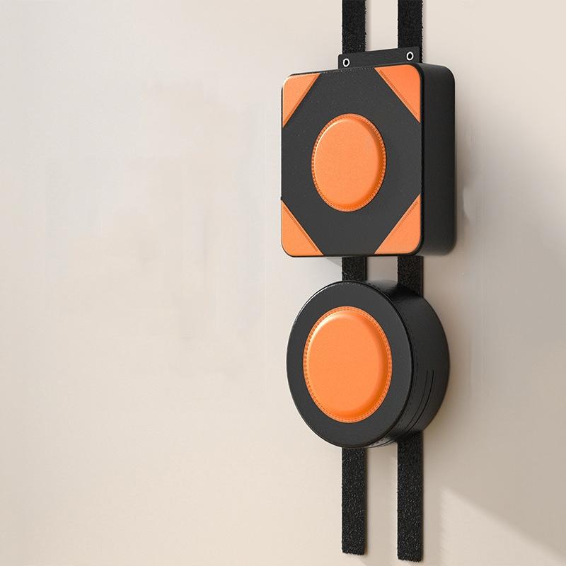 Wall-mounted device with orange circular components on a beige background