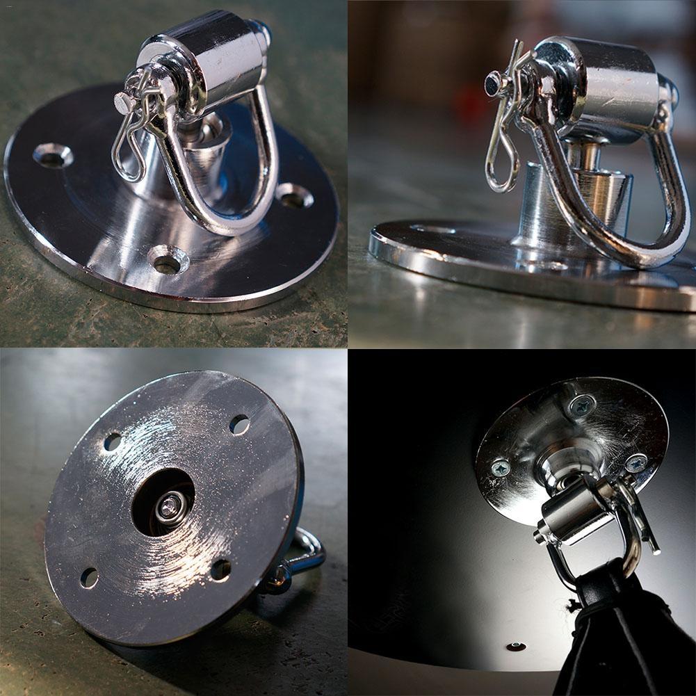Metallic latch or hook component shown from multiple angles on a reflective surface.