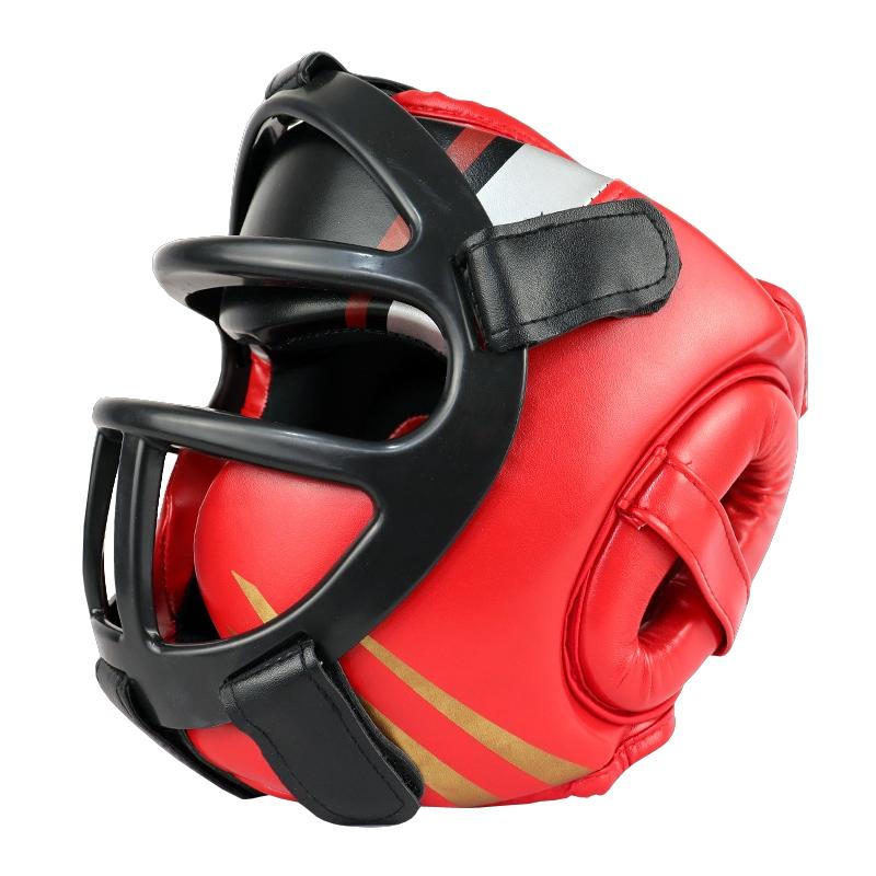 Red boxing headgear with black face guard on a white background