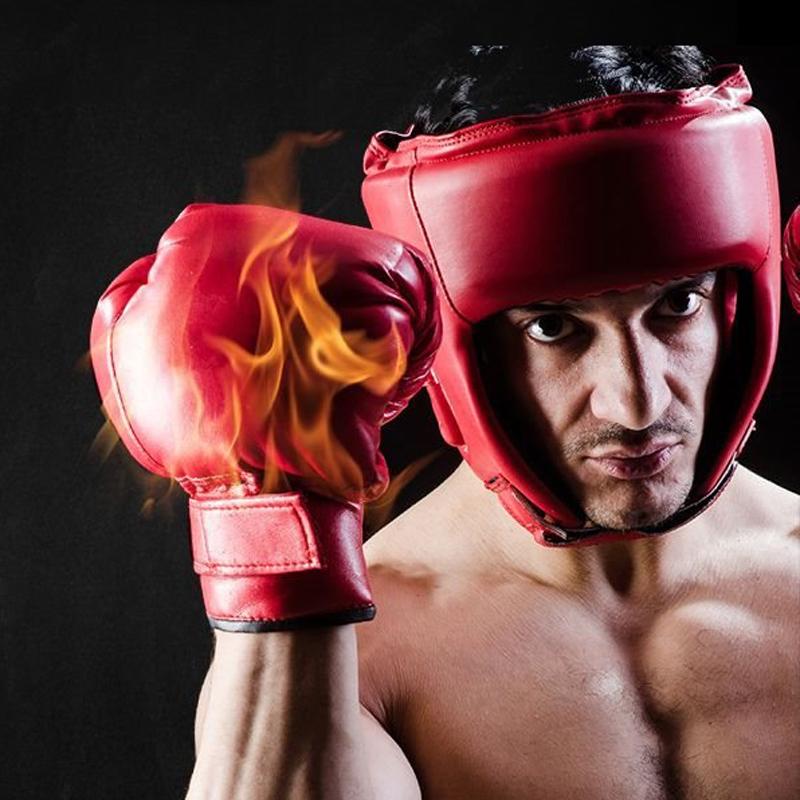 Boxer wearing red boxing gloves with flames and a red headgear on a black background