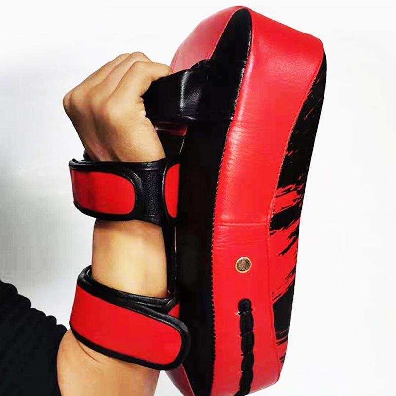 Red and black martial arts training pad held by a person