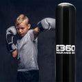Child in boxing gloves posing next to a punching bag with 'E360 Endurance 360' branding.
