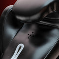 Close-up of a black leather seat with a white component