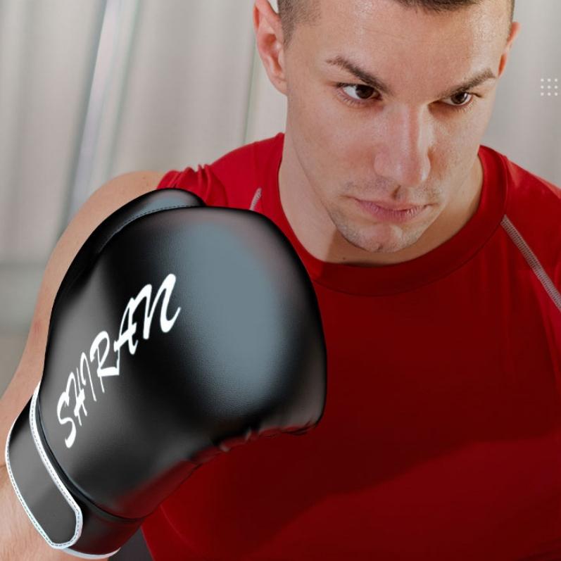 Man wearing a black boxing glove with 'SHIRAN' branding.