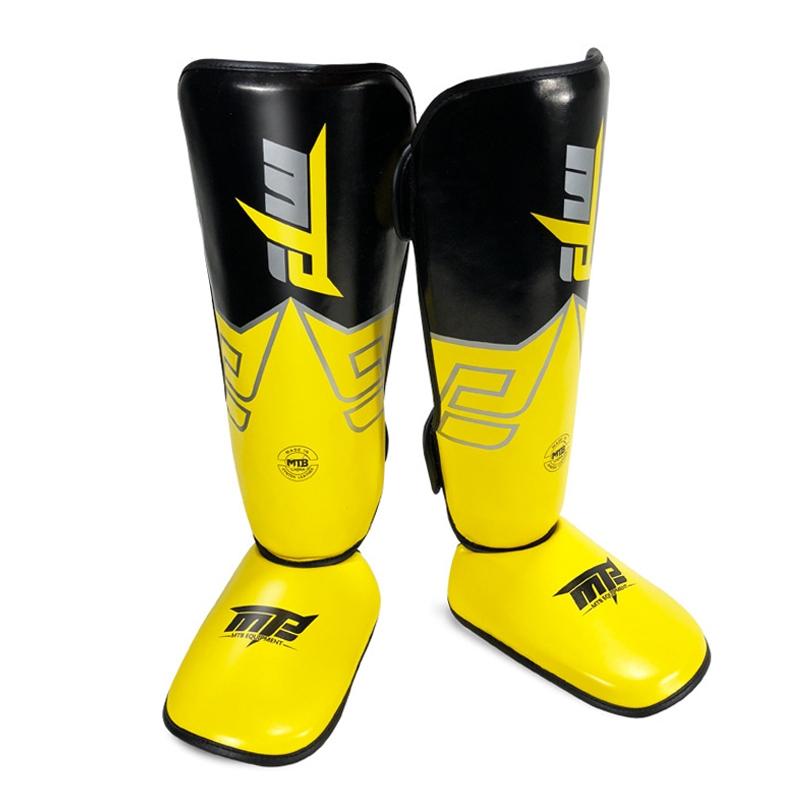 Yellow and black shin guards with a brand logo on a white background