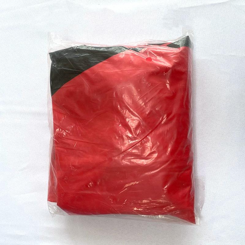 Red and black item wrapped in clear plastic on a white background