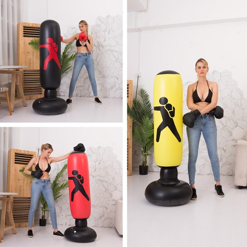 Woman interacting with inflatable punching bags in a home setting