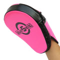 Pink and black martial arts training pad held by a person on a white background