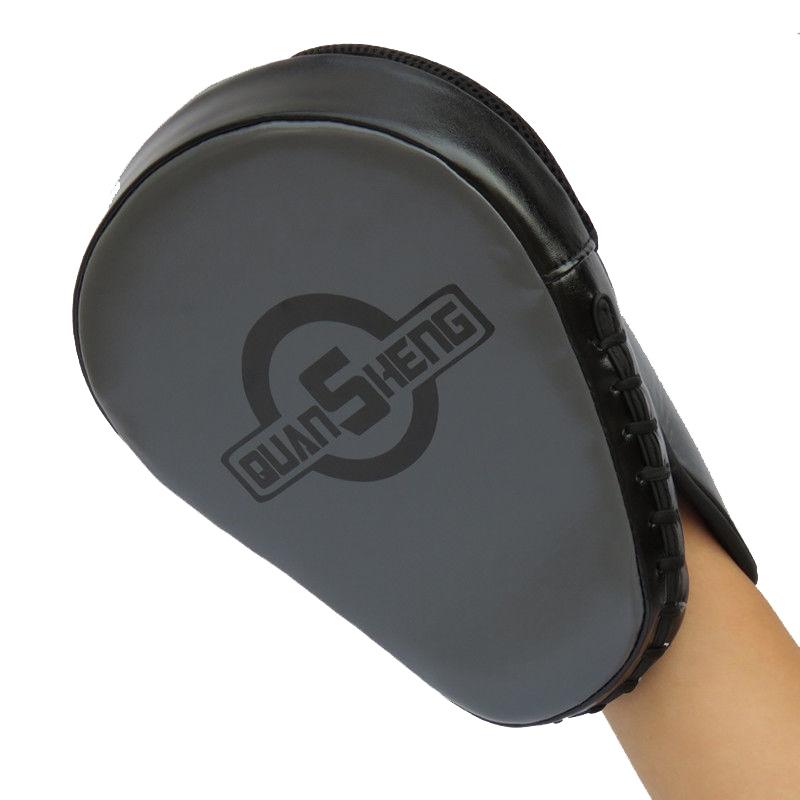 Black martial arts training pad held by a hand with 'Quan Sheng' branding.