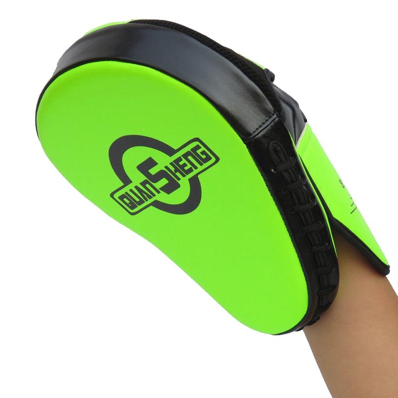 Green and black training pad held by a person on a white background