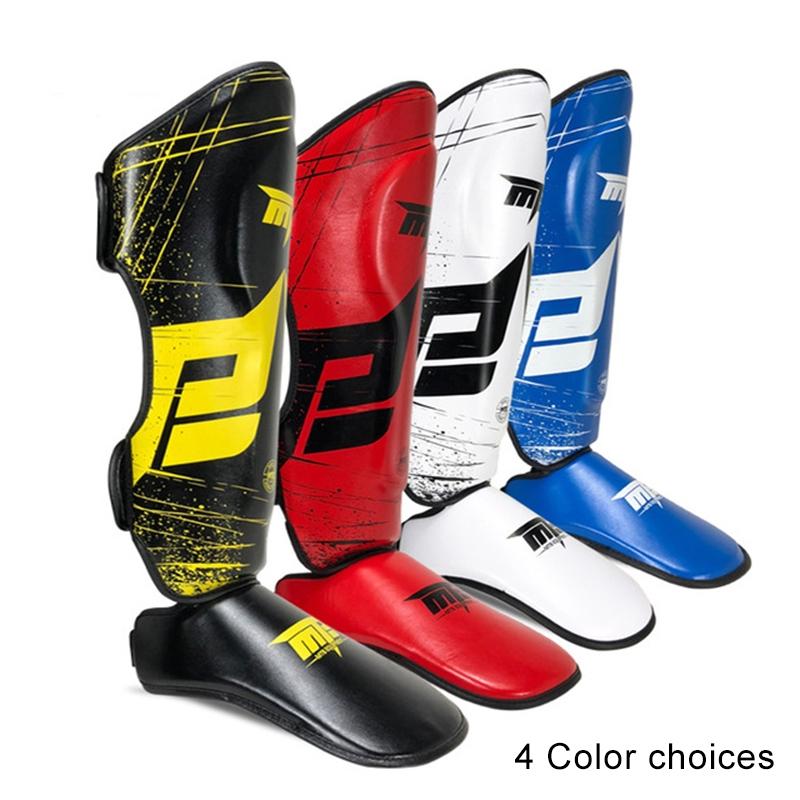 Four pairs of shin guards in different colors on a white background