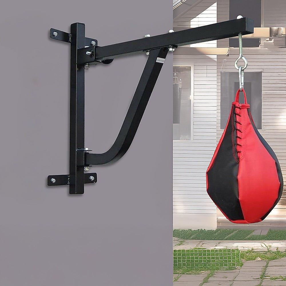 Black punching bag stand attached to a gray wall with a red and black punching bag hanging from it.