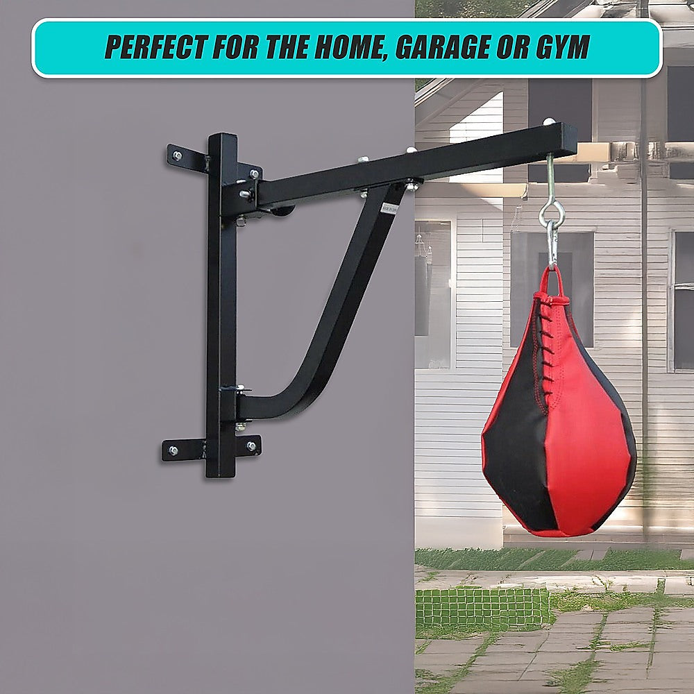 Wall-mounted punching bag stand with a red and black punching bag, set against a house exterior.