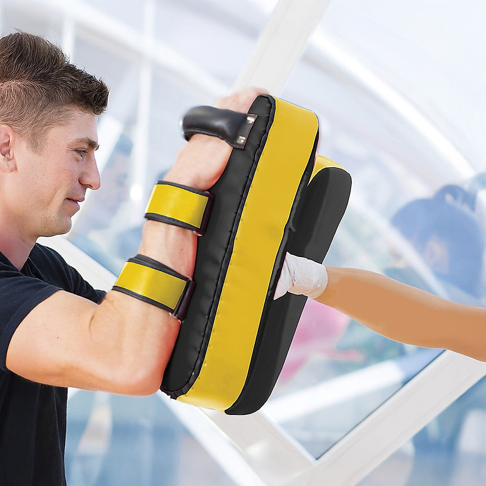 Black and yellow boxing pads with 'RTM' branding on a white background