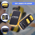 Black and yellow martial arts training pads with 'RTM' branding on a blurred background.