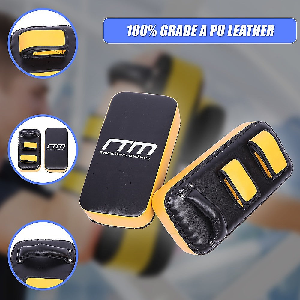 Black and yellow martial arts training pads with 'RTM' branding on a blurred background.