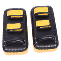 Pair of black and yellow martial arts knee pads on a white background