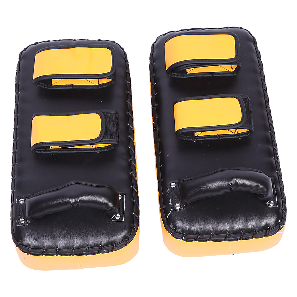 Pair of black and yellow martial arts knee pads on a white background