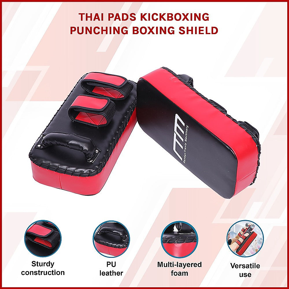 Red and black Thai pads for kickboxing with brand logo on a light pink background