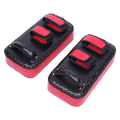 Pair of red and black martial arts knee pads on a white background