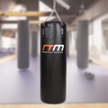 Black punching bag with 'Randy Travis Machinery' logo in a gym setting